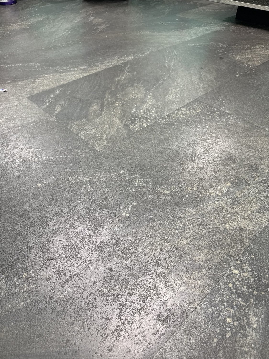 Close-up of a mottled gray interior floor surface