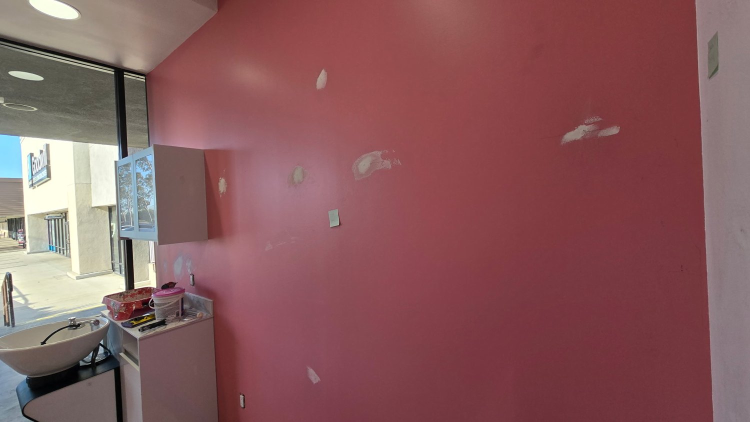 Pink wall with visible light-colored patches
